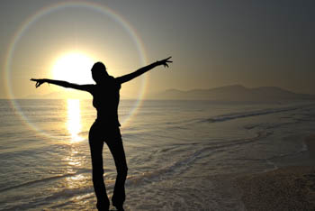 A young woman exults the onset of the vivid sunset in french riviera...